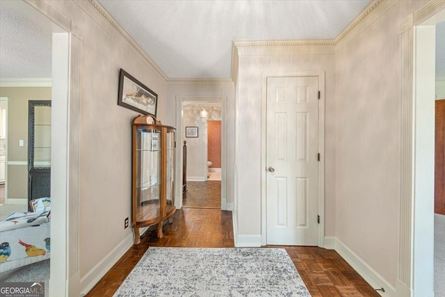 hallway featuring crown molding, a textured ceiling, and baseboards
