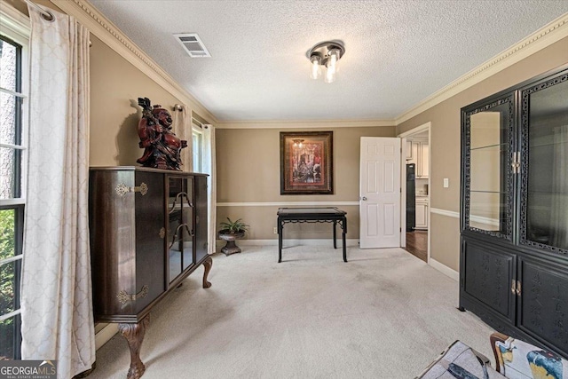 sitting room featuring visible vents, a healthy amount of sunlight, ornamental molding, and carpet floors