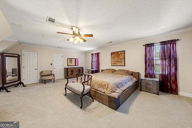 bedroom with baseboards, visible vents, light carpet, and crown molding