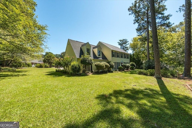 view of side of property featuring a yard