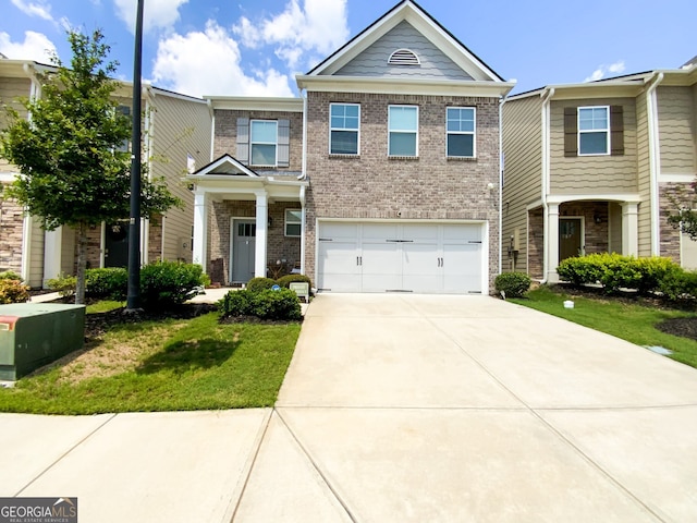 multi unit property featuring a front lawn and a garage