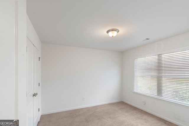 empty room featuring light carpet