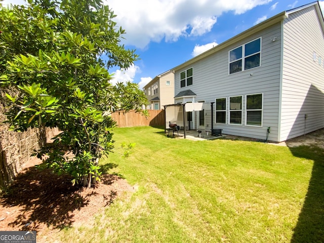 rear view of house featuring a yard and a patio area