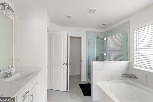 bathroom featuring vanity, separate shower and tub, and tile patterned floors