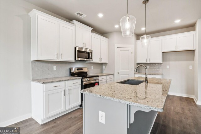 kitchen with sink, white cabinets, a center island with sink, and appliances with stainless steel finishes