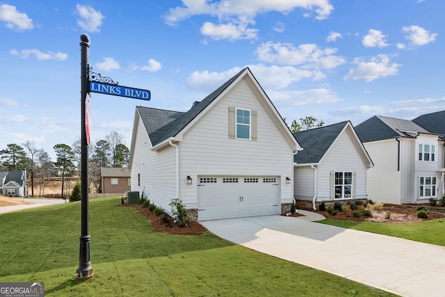 view of property with central AC, a garage, and a front lawn