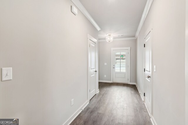 entryway with crown molding and dark hardwood / wood-style flooring