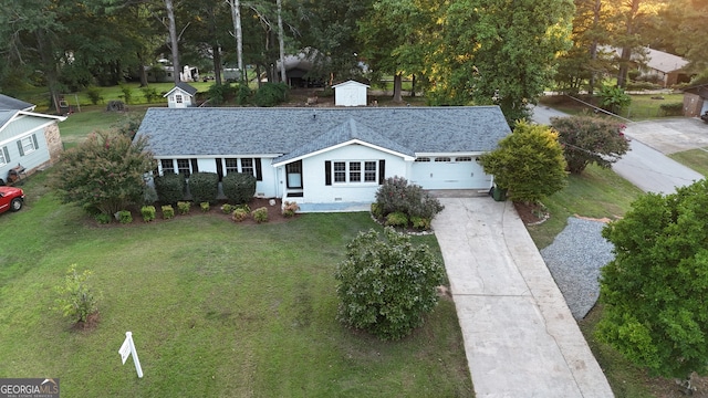 ranch-style home with a garage and a front yard