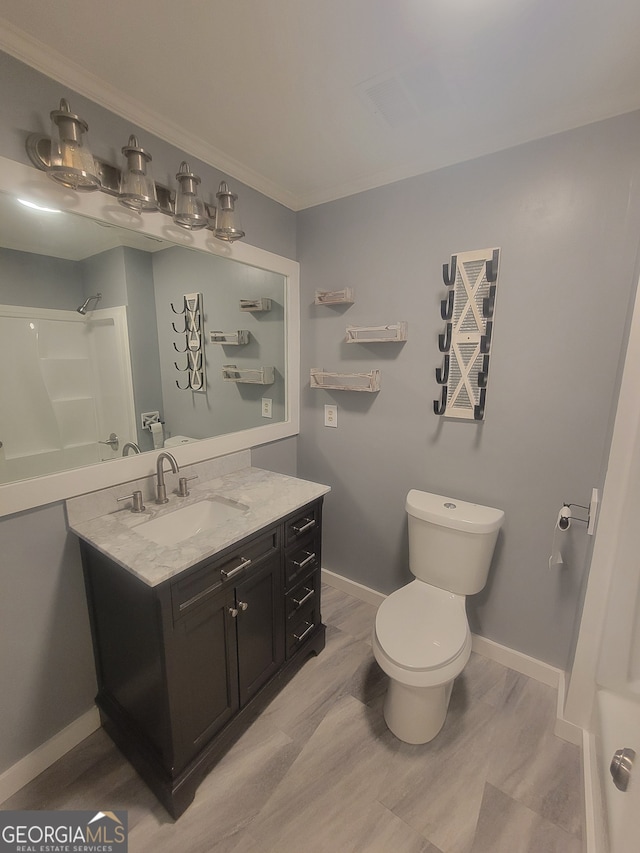 bathroom featuring a shower, vanity, and toilet