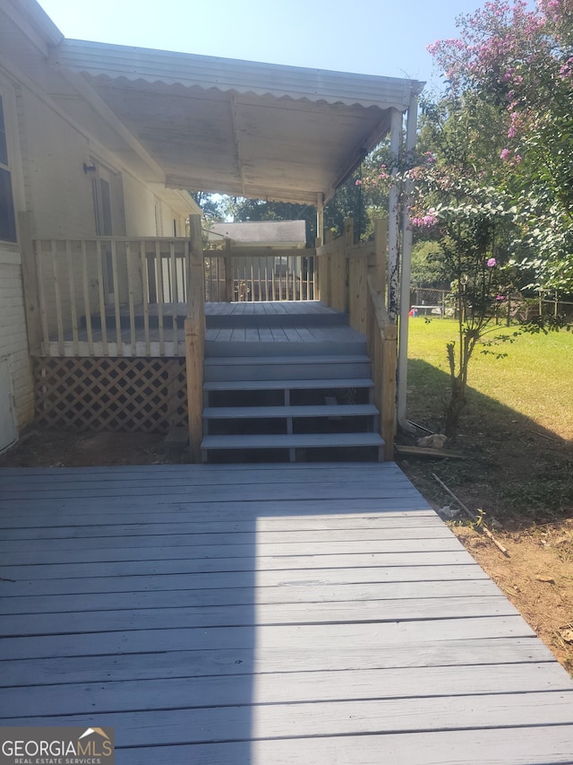 wooden terrace with a yard