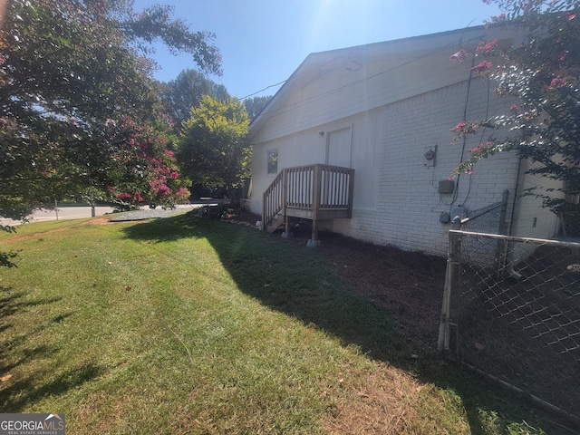 view of side of property with a lawn