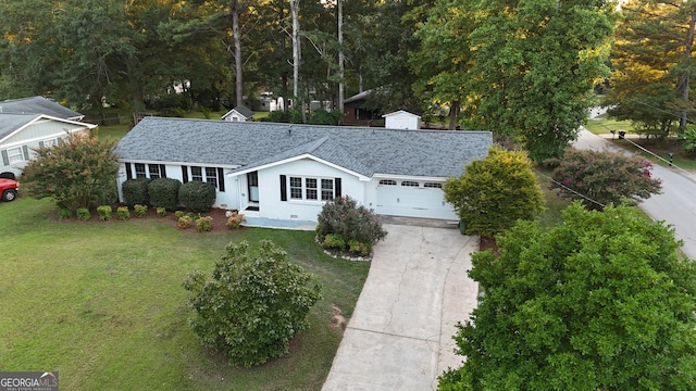 ranch-style house featuring a garage and a front yard