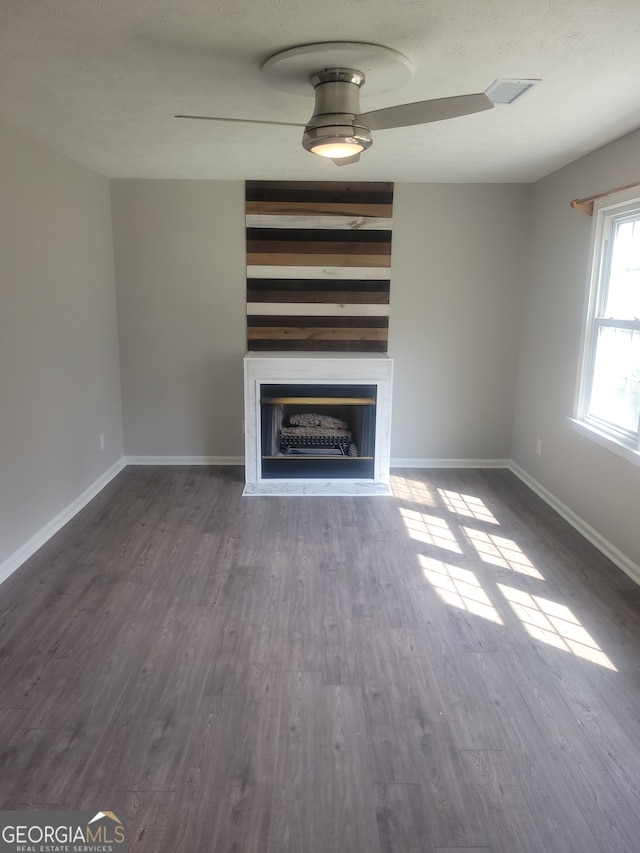 unfurnished living room with ceiling fan and hardwood / wood-style floors