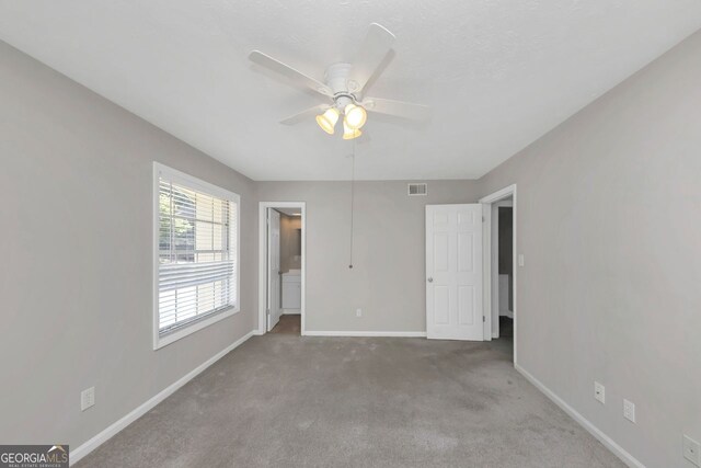 interior space featuring carpet floors and ceiling fan