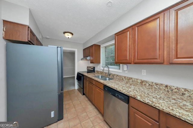 kitchen featuring sink, light stone counters, dishwasher, range with electric stovetop, and refrigerator