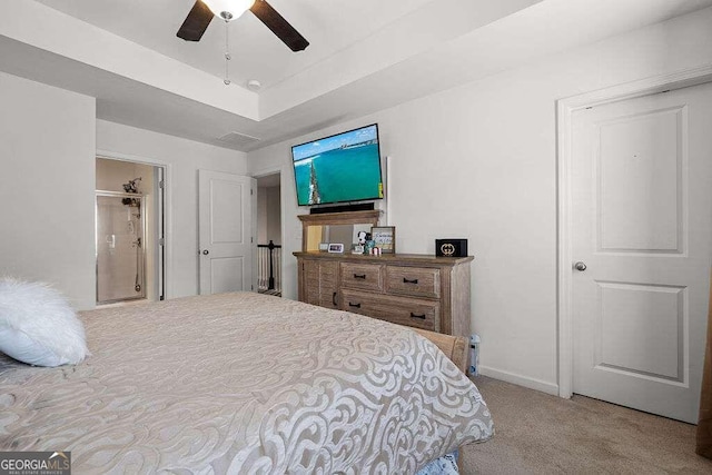 carpeted bedroom featuring a raised ceiling, a ceiling fan, and baseboards