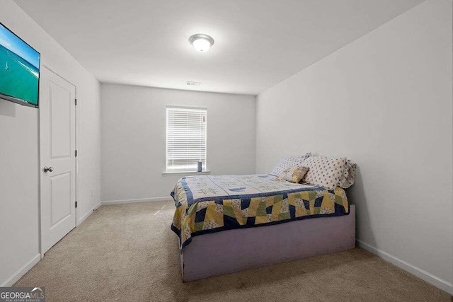 bedroom with light colored carpet, visible vents, and baseboards