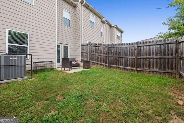 view of yard featuring a fenced backyard, a patio area, and cooling unit