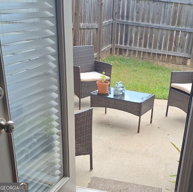 view of patio featuring fence