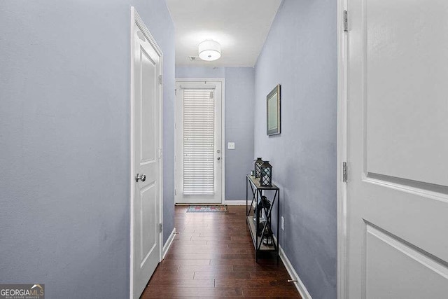 entryway featuring dark wood-style flooring and baseboards