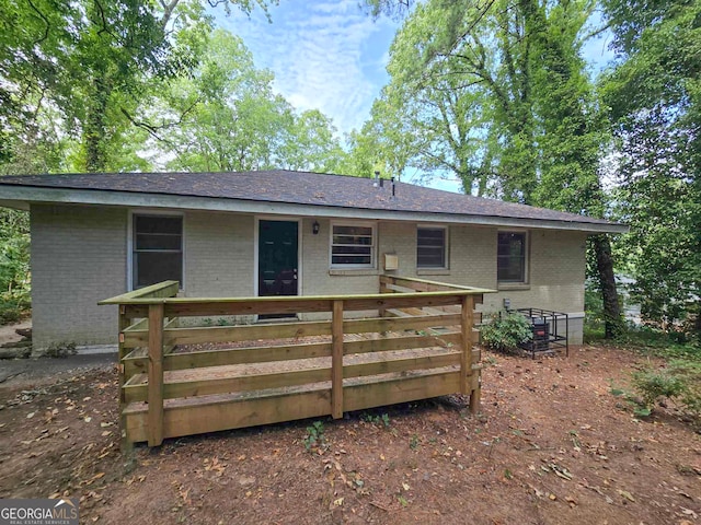 back of property with a wooden deck