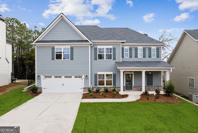 craftsman inspired home featuring a porch, a front yard, and a garage