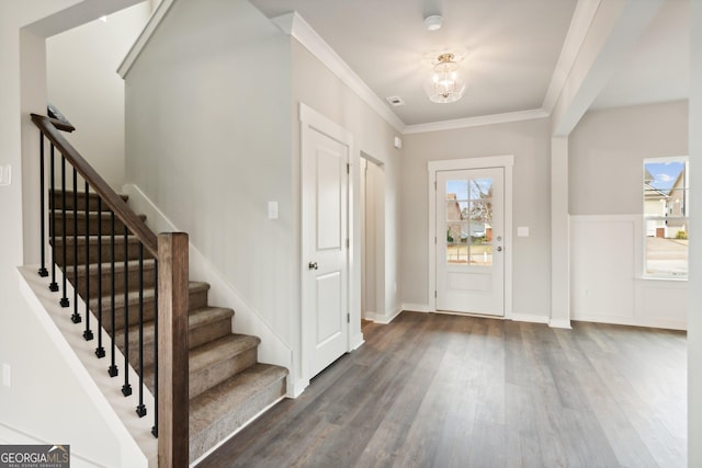 entryway with dark hardwood / wood-style flooring and ornamental molding