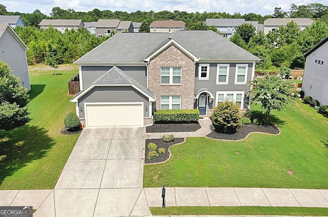 view of front of home with a garage and a front yard