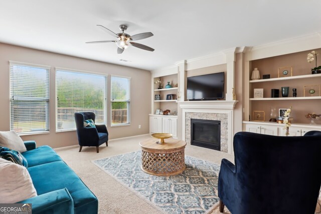 carpeted living room with ceiling fan