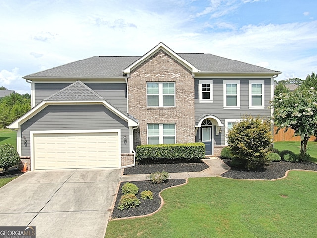 view of front of home featuring a garage and a front yard