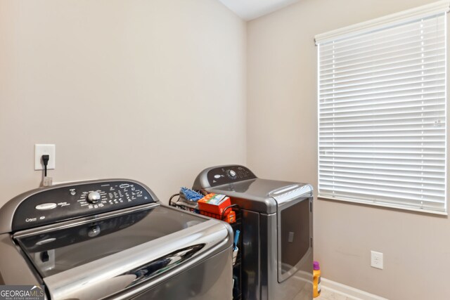 clothes washing area with washer and clothes dryer