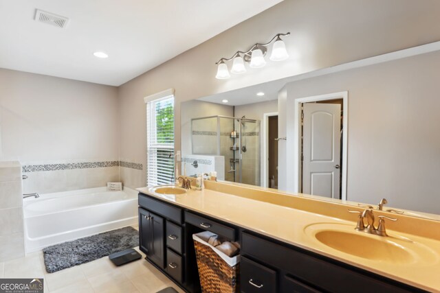 bathroom with shower with separate bathtub, vanity, and tile patterned floors