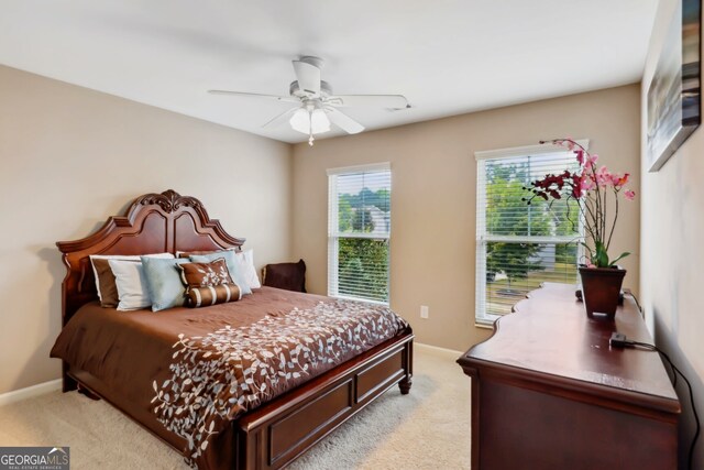 bedroom featuring light carpet and ceiling fan