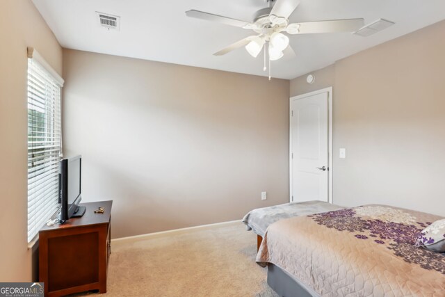 bedroom with ceiling fan and carpet flooring