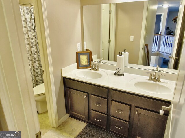 bathroom featuring vanity, toilet, and walk in shower