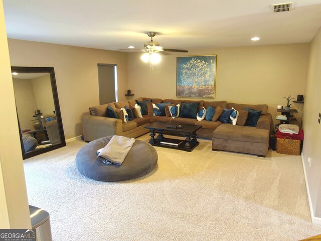 living room featuring ceiling fan and light colored carpet