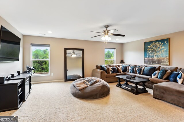 carpeted living room featuring ceiling fan