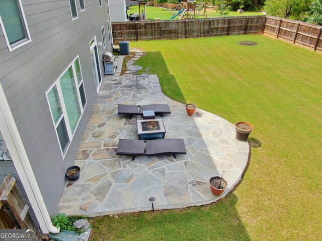 view of yard with central AC unit and a patio