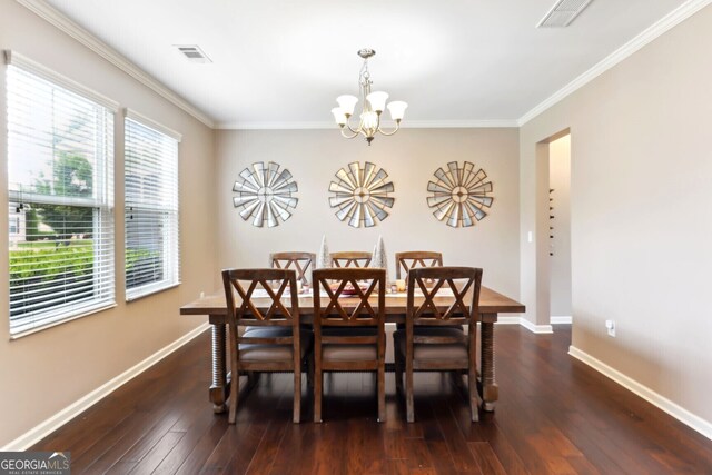 dining room featuring ornamental molding, a chandelier, and dark hardwood / wood-style flooring