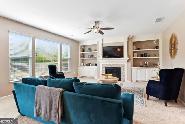 carpeted living room featuring ceiling fan