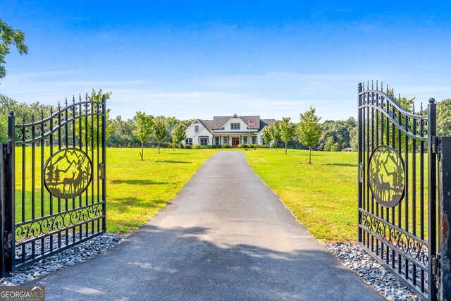 view of gate with a yard