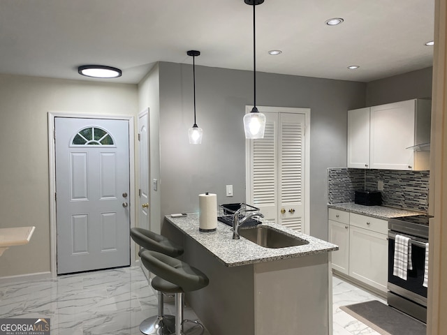 kitchen with white cabinets, sink, light stone counters, and stainless steel electric stove