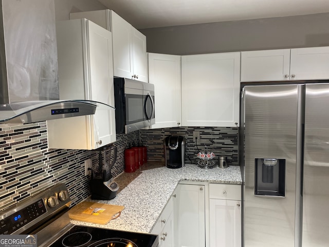 kitchen featuring island exhaust hood, appliances with stainless steel finishes, backsplash, and white cabinetry