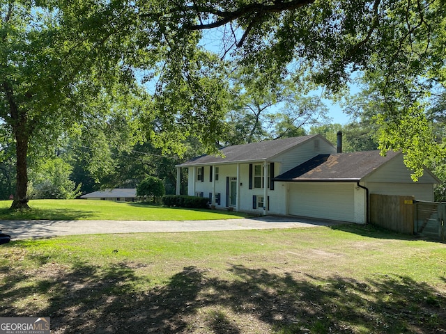 view of front of property featuring a garage and a front lawn