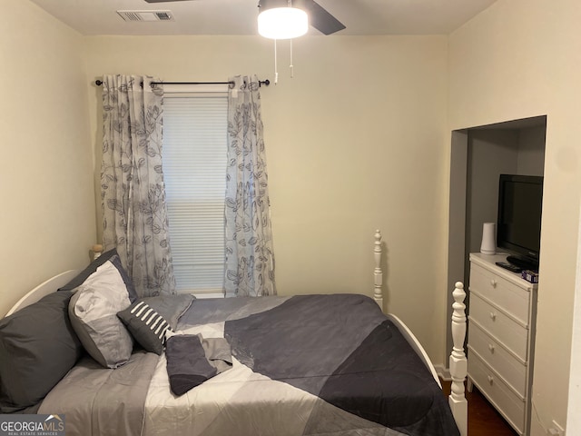 bedroom featuring ceiling fan and dark wood-type flooring