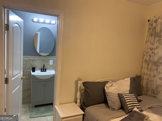 bathroom with vanity and tile walls