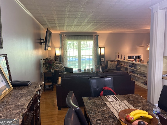 dining space featuring crown molding, hardwood / wood-style flooring, and ceiling fan