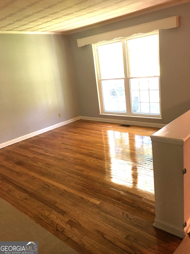 empty room featuring dark hardwood / wood-style flooring