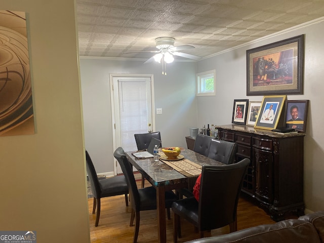 dining space with ceiling fan, crown molding, and dark hardwood / wood-style flooring