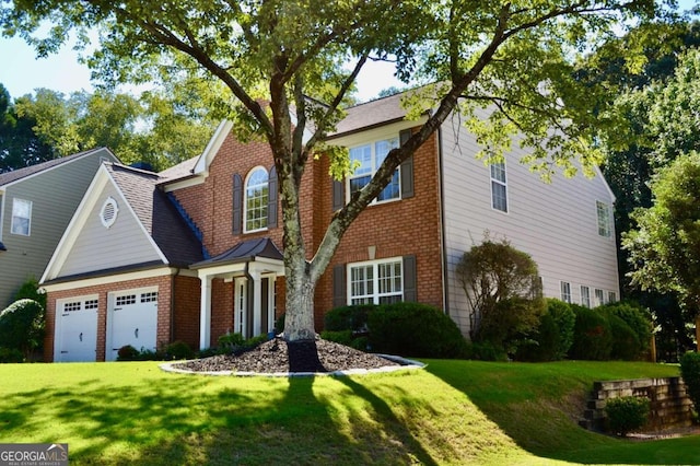 view of front facade with a garage and a front lawn